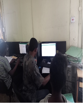 TeamO staff scanning student files into the digitisation system
